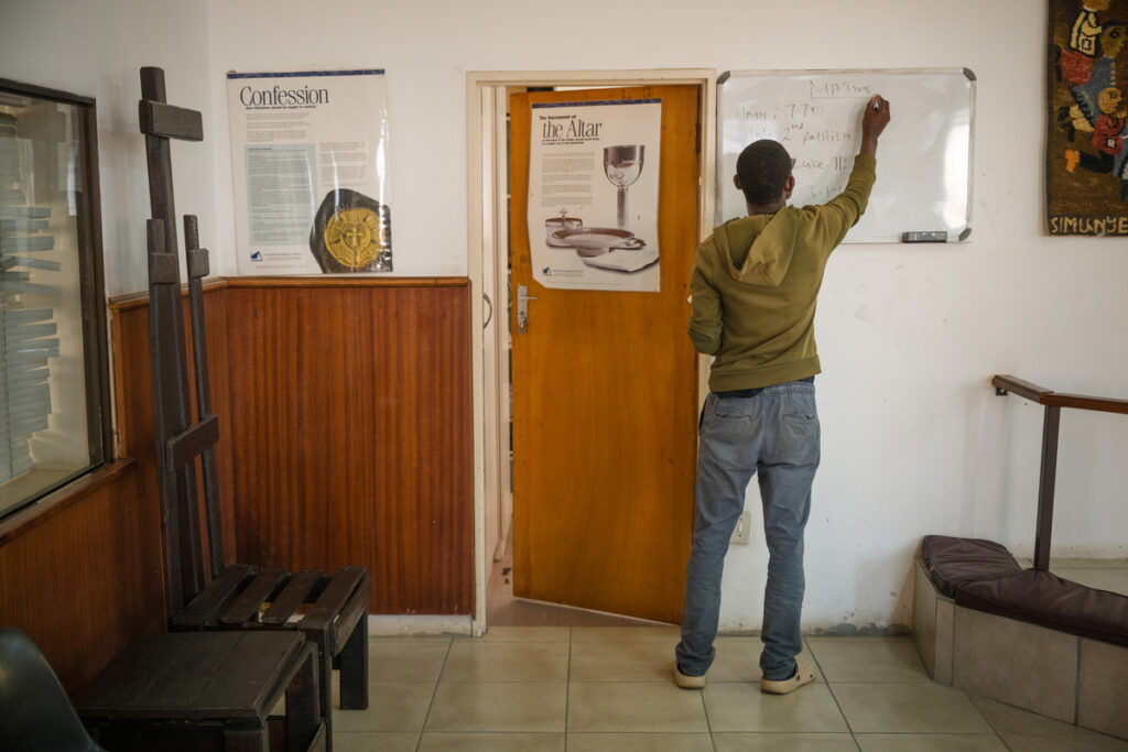 Seminarian Happy Maganga writes the Scripture readings and hymns on the whiteboard before Matins at Lutheran Theological Seminary (LTS) in Tshwane, South Africa, in August 2025.
