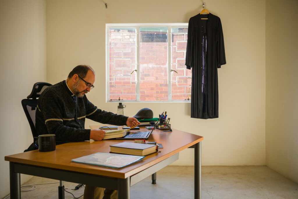 The Rev. Volmir da Rocha reads Scripture in his office at the seminary.